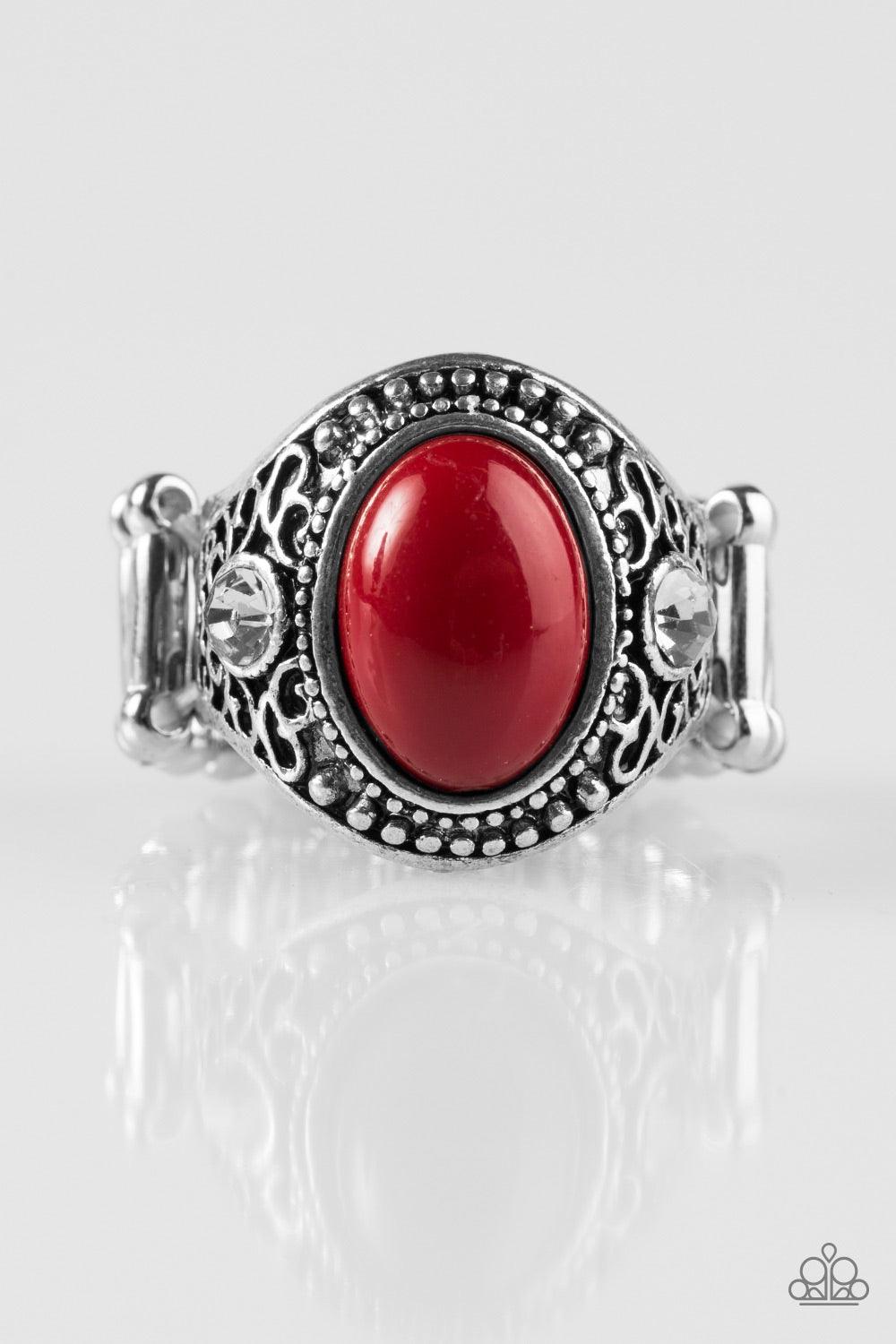 Paparazzi Accessories Beautifully Bali - Red Brushed in an antiqued shimmer, frilly filigree climbs the finger, coalescing into a vintage inspired frame. Flanked by glittery white rhinestones, a red bead is pressed into the center of the frame for a color