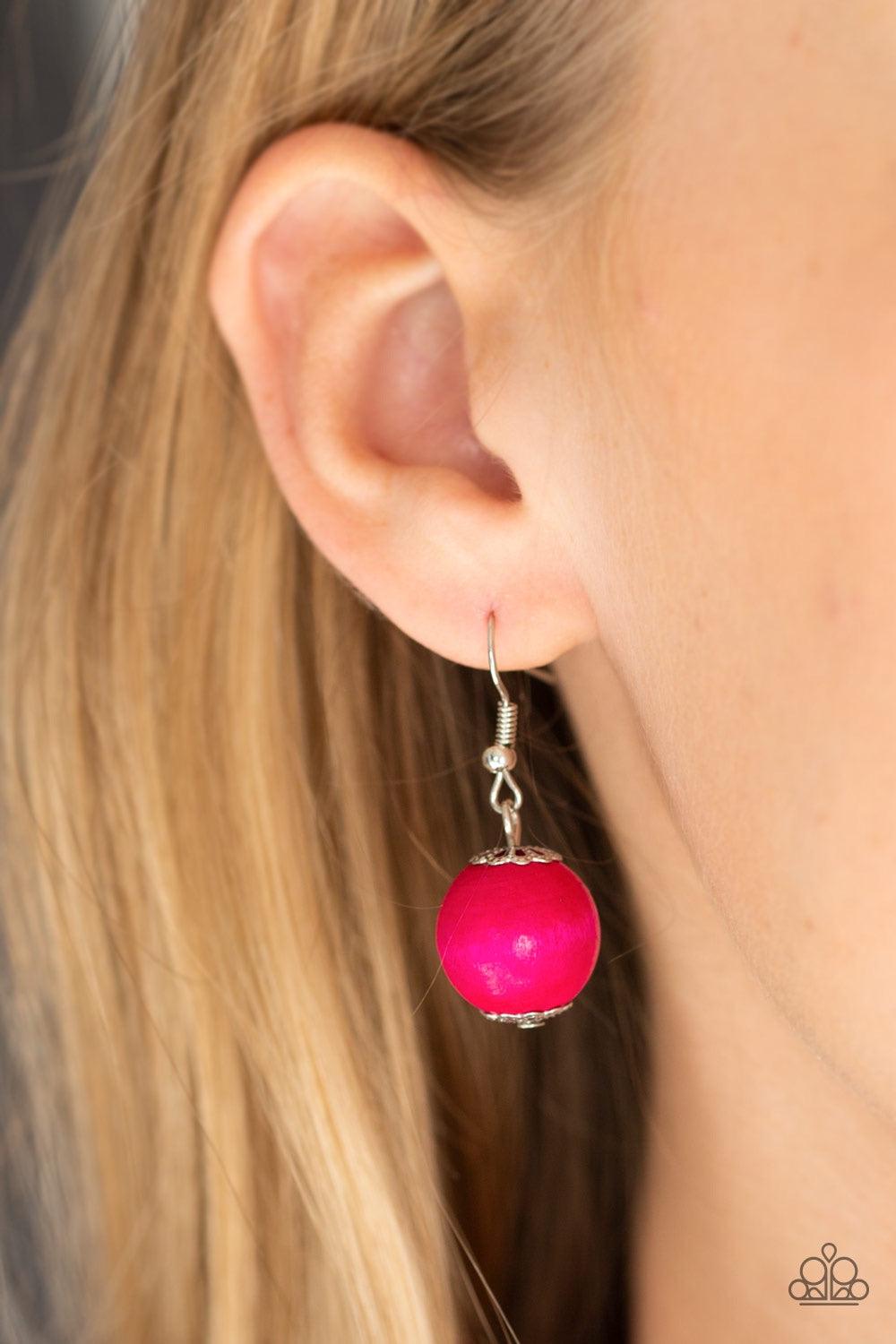 Paparazzi Accessories Panama Panorama - Pink Infused with dramatic silver beads, an array of vivacious pink wooden beads drape across the chest for a summery look. Features a button-loop closure. Jewelry