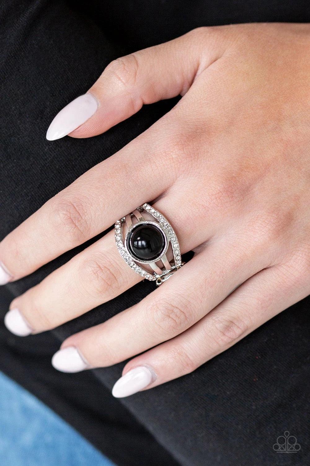 Paparazzi Accessories A Big Break - Black Radiating with glassy white rhinestones, row after row of glittering silver bars arc across the finger. A shiny black bead is pressed into the center of the layered bands, adding a dramatically refined finish to t