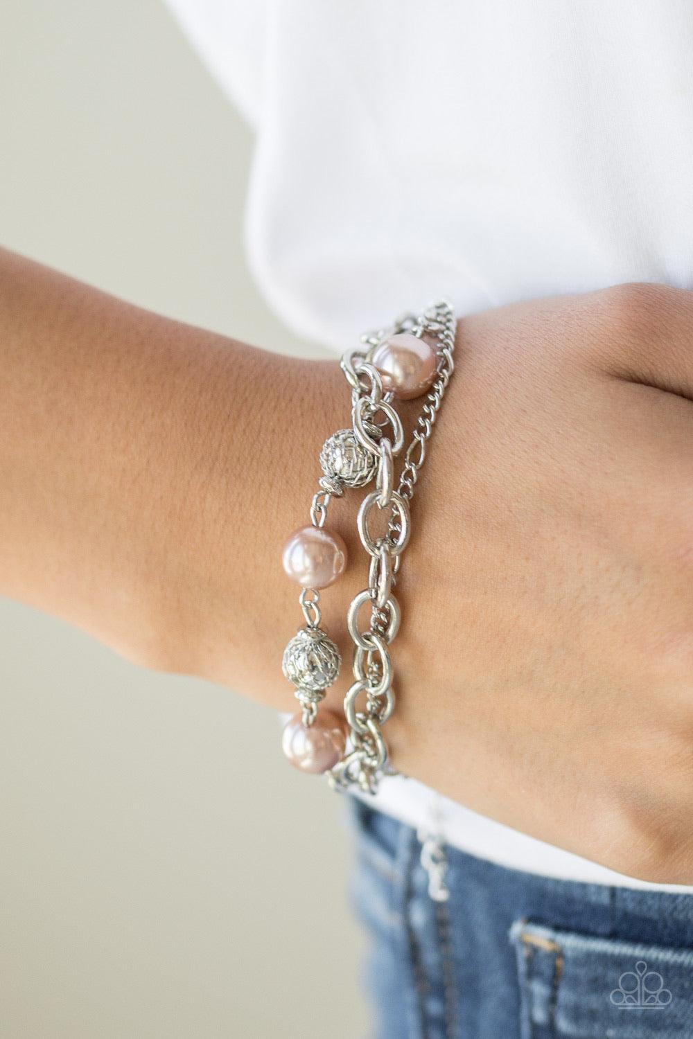 Paparazzi Accessories Vintage Variety ~Brown Wrapped in wire mesh, classic silver beads join pearly brown beads along a shimmery silver chain. Varying in size and shimmer, mismatched silver chains join the beaded strand around the wrist for a refined fini
