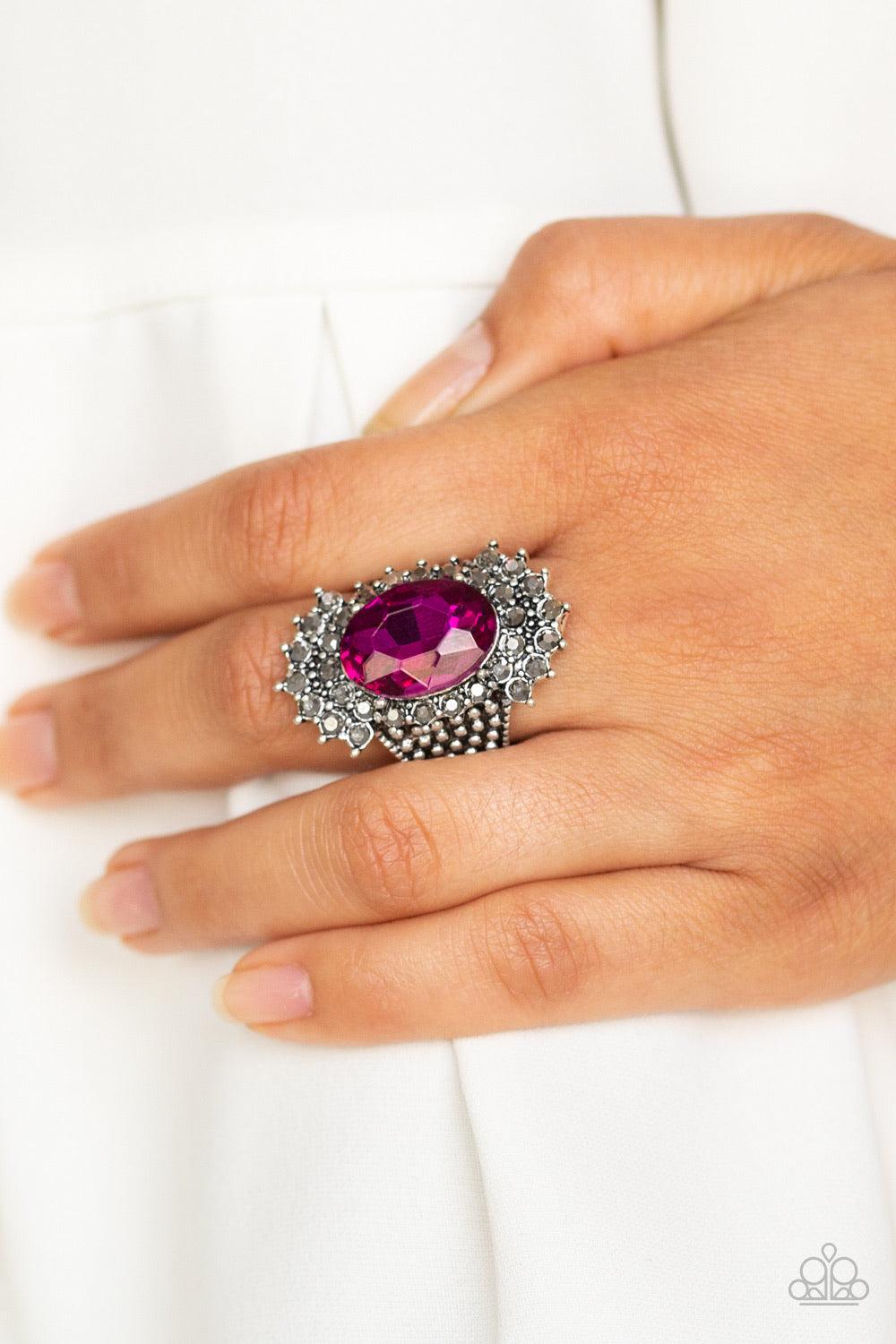 Paparazzi Accessories Him and HEIR - Pink Glittery hematite rhinestones flare out from a dramatically oversized pink rhinestone center. The regal frame sits atop a silver studded band for a statement-making finish. Features a stretchy band for a flexible