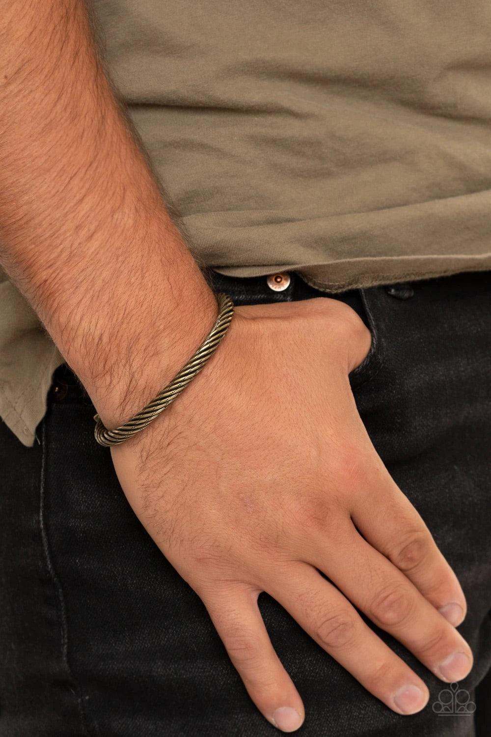 Paparazzi Accessories Block It Out - Brass Featuring two brass square fittings, hammered brass bars twist into a rustic cuff around the wrist. Sold as one individual bracelet. Jewelry