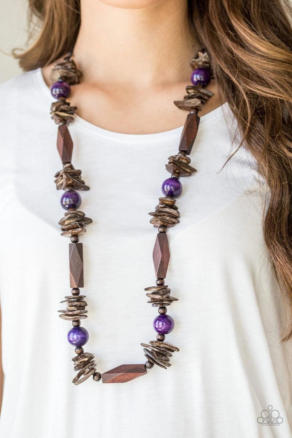 Paparazzi Accessories Cozumel Coast - Purple Featuring round, faceted, and distressed finishes, mismatched brown wooden beads are threaded along shiny brown cording. Vivacious purple wooden beads trickle between the earthy accents, adding a colorful finis