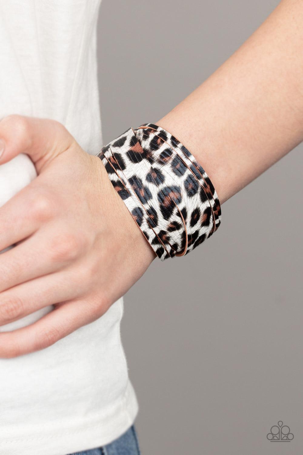 Paparazzi Accessories Hey GRRirl - White Painted in a lifelike white, brown, and black cheetah print, thick leather bands have been spliced into layers that wave across the wrist for a wild look. Features an adjustable snap closure. Sold as one individual