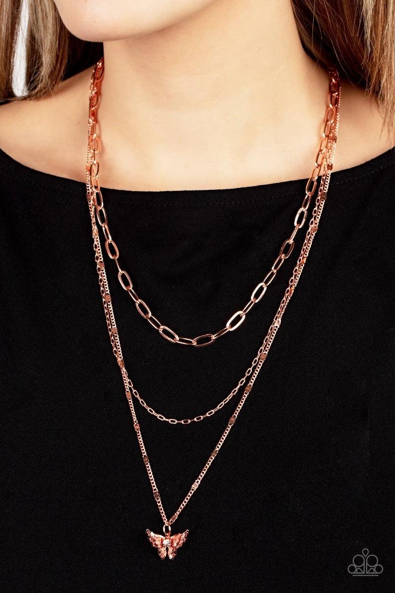 Paparazzi Accessories Bountiful Butterflies - Copper Dotted with a dainty white rhinestone, a decoratively layered shiny copper butterfly swings from the bottom of a display of mismatched shiny copper chains for a whimsically fluttering fashion. Features