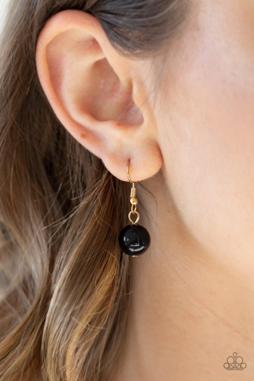 Paparazzi Accessories 5th Avenue Fleek - Black A collection of classic and imperfect black beads dangle from a web of interlocking gold links below the collar, adding a modern twist to the timeless palette. Features an adjustable clasp closure. Sold as on