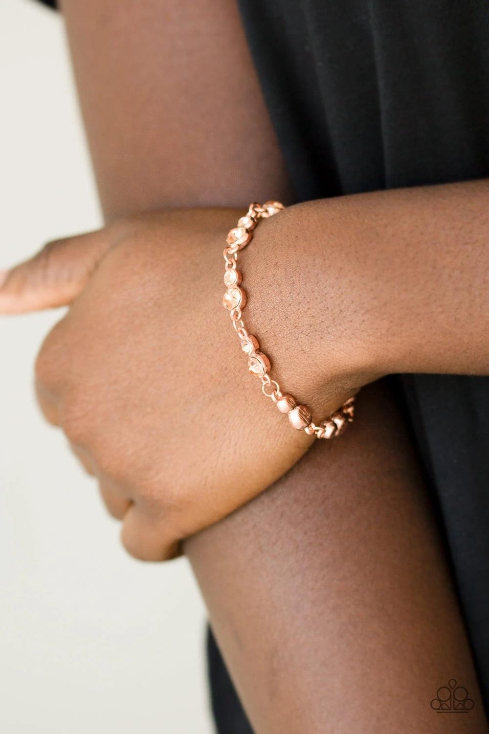 Paparazzi Accessories Twinkle Twinkle Little STARLET ~Copper Varying in size, pairs of glassy peach rhinestones are encrusted along shiny copper frames and linked around the wrist for a timeless finish. Features an adjustable clasp closure. Sold as one in