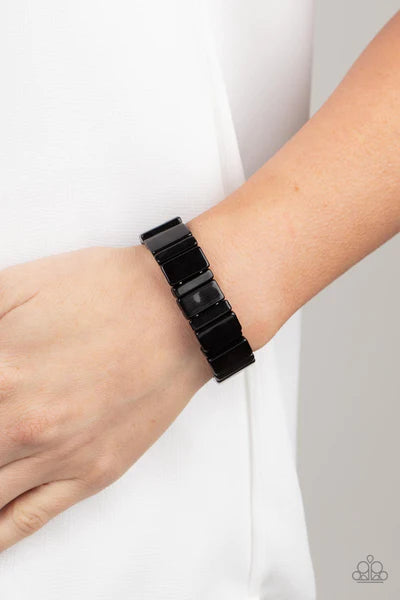 Paparazzi Accessories In Plain Sightseer - Black Painted in a shiny black finish, a mismatched collection of acrylic rectangular frames are threaded along stretchy bands around the wrist for a bold pop of color. Sold as one individual bracelet. Bracelets