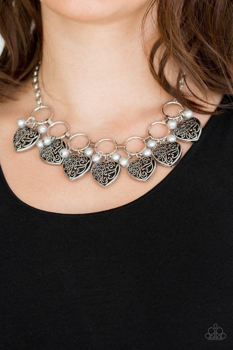 Paparazzi Accessories Very Valentine - Silver Infused with classic silver pearls, vintage locket-like heart frames swing from the bottoms of bold silver hoops, creating a flirtatious fringe below the collar. Features an adjustable clasp closure. Sold as o