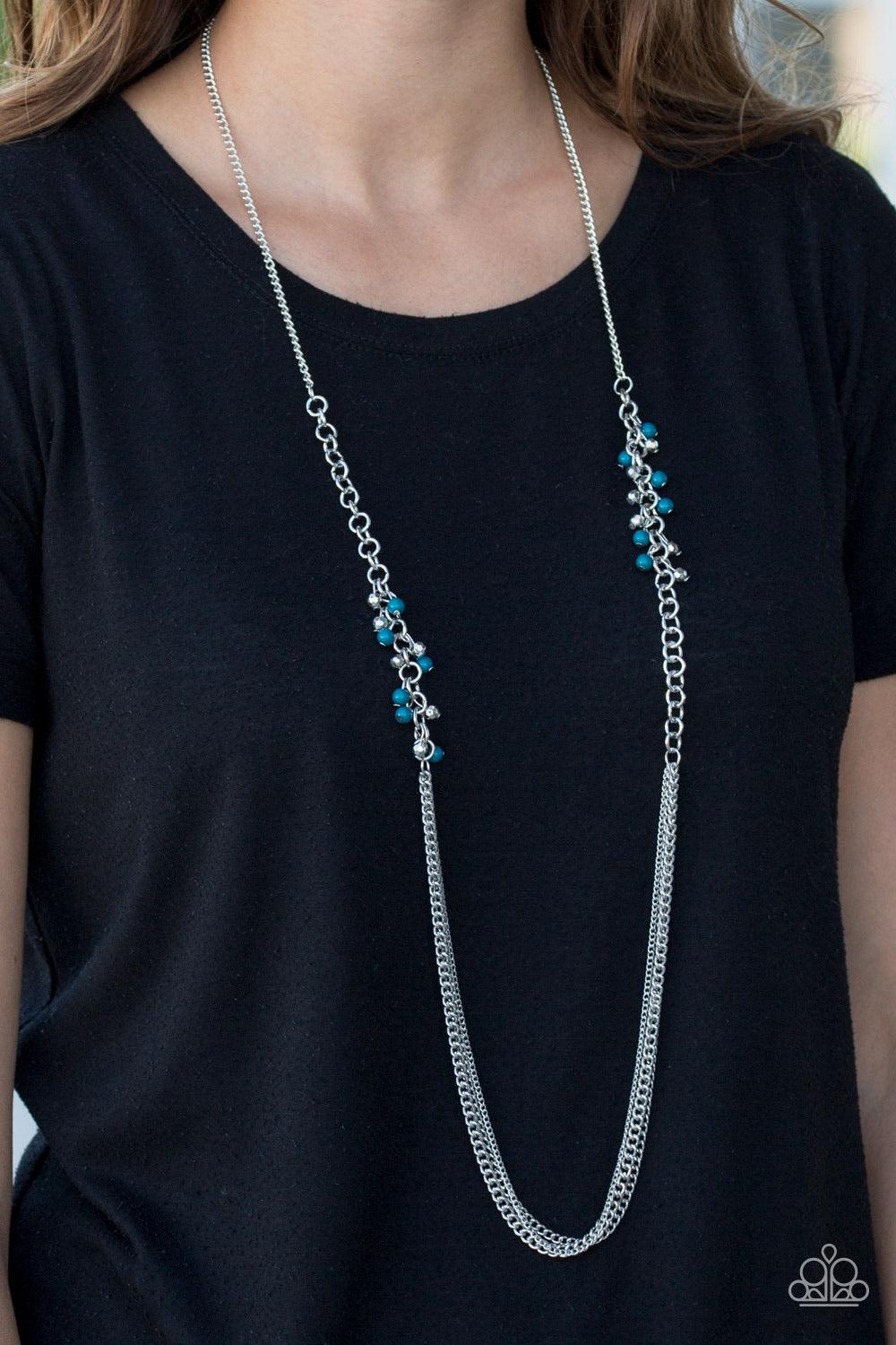 Paparazzi Accessories In For A Surprise - Blue Faceted silver and blue beading trickle along a bold silver chain. The colorful beading gives way to layers of mishmash silver chain, creating shimmery layers across the chest. Features an adjustable clasp cl