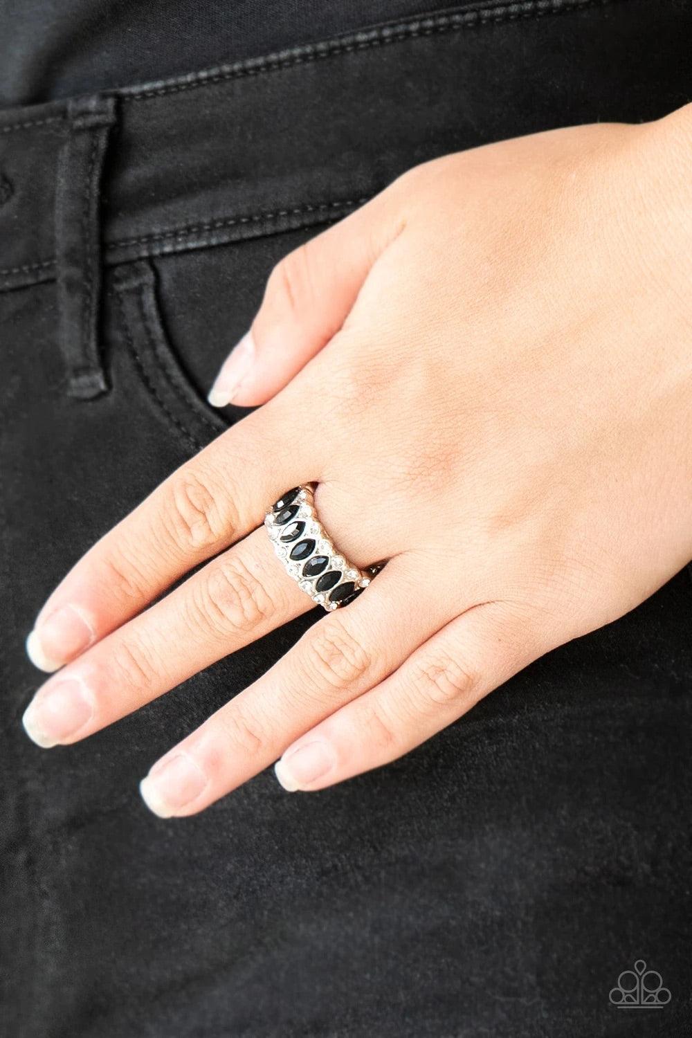 Paparazzi Accessories Radical Riches - Black Featuring regal marquise style cuts, glittery black rhinestones are encrusted down the center of a silver band radiating with glassy white rhinestones for an edgy look. Features a stretchy band for a flexible f