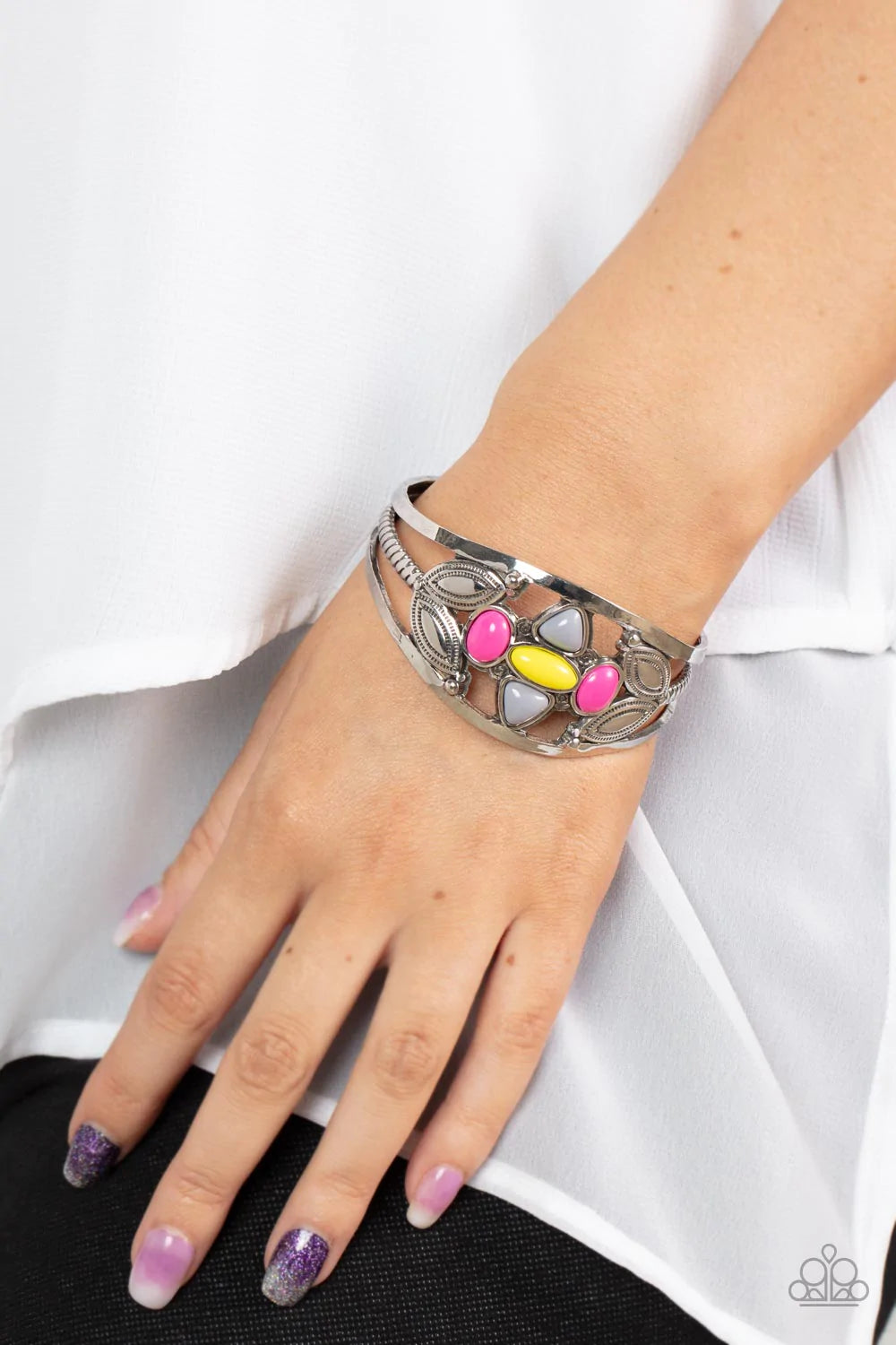 Paparazzi Accessories Caribbean Cabana - Multi A shapely assortment of Illuminating, Ultimate Gray, and Fuchsia Fedora acrylic beads adorn the center of a layered silver cuff adorned in leafy silver texture, creating a vivacious pop of color around the wr
