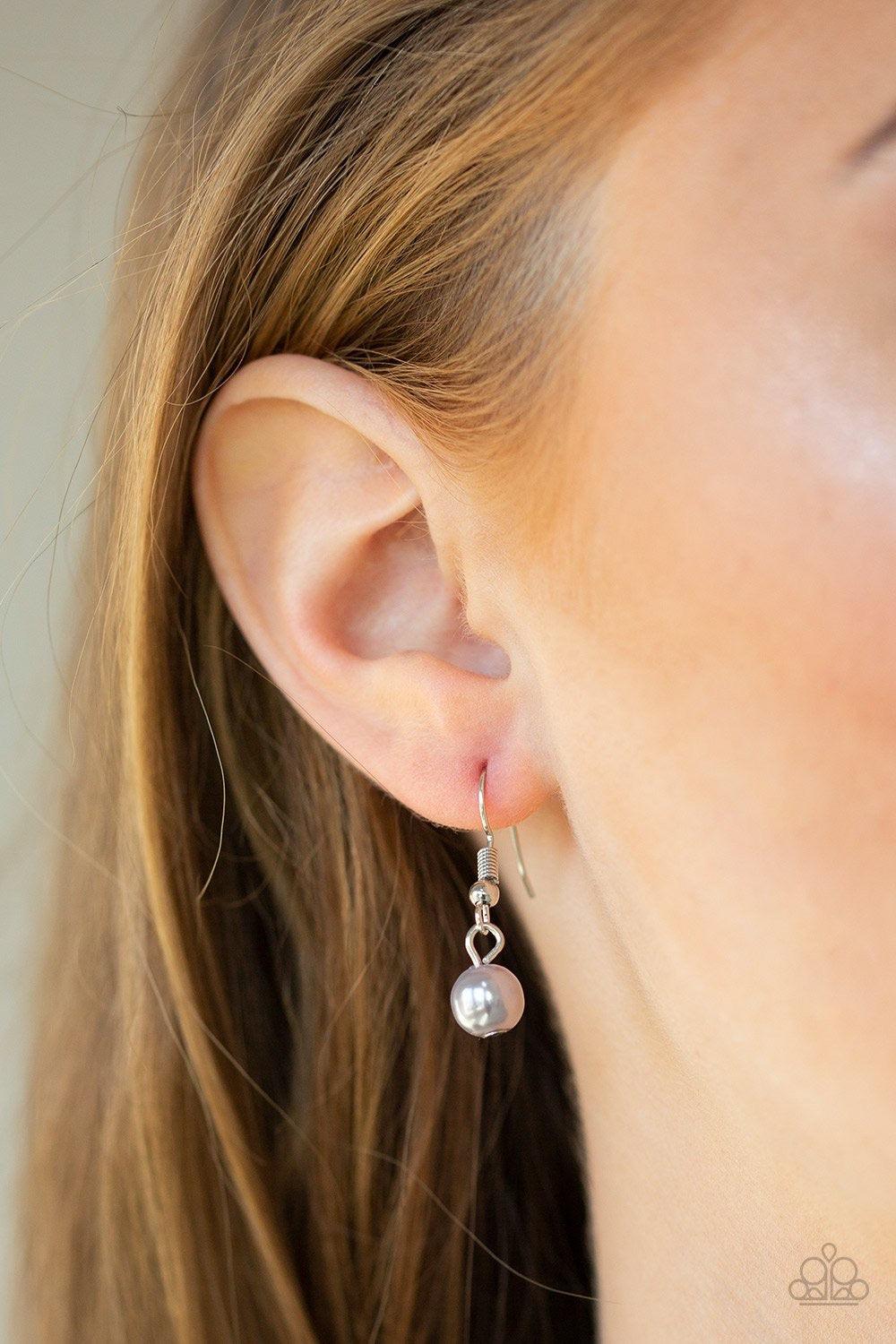 Paparazzi Accessories Teardrop Serenity - Silver A collection of gray pearls, shiny silver beads, and glassy white teardrops trickle along an extended chain that swings from the bottom of a classic silver chain. An over sized teardrop swings from the bott