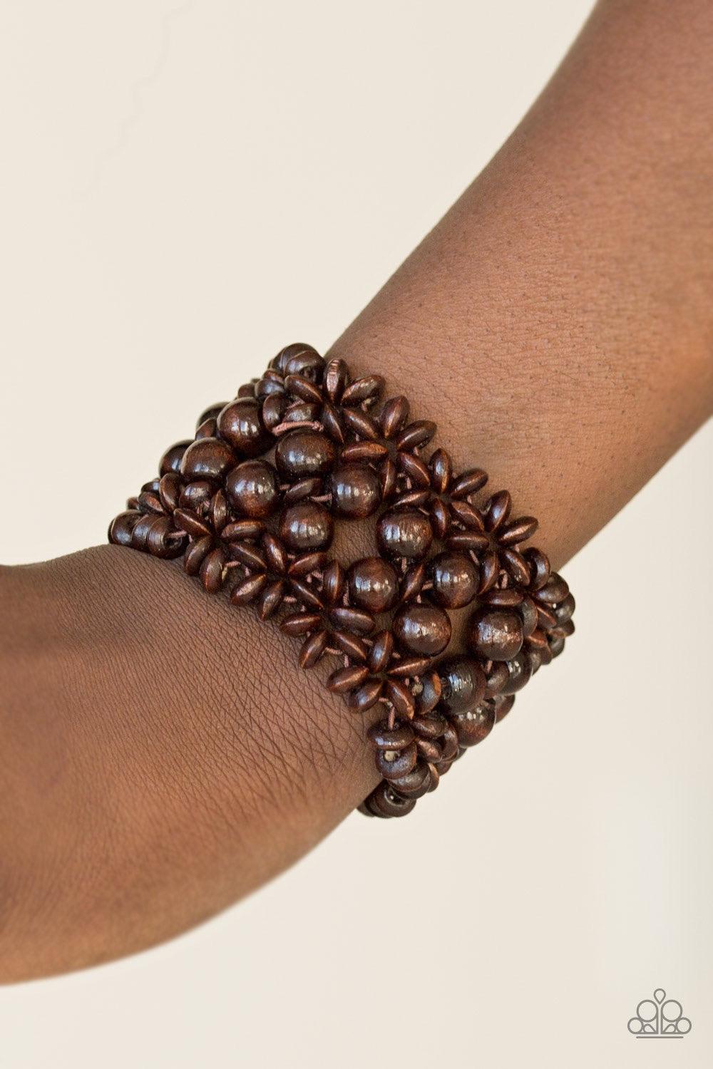 Paparazzi Accessories Tropical Bliss - Brown Brown wooden accents are threaded along elastic stretchy bands, creating an ornate bracelet. Rounded brown wooden beads line the center of the summery pattern for a bold finish. Jewelry