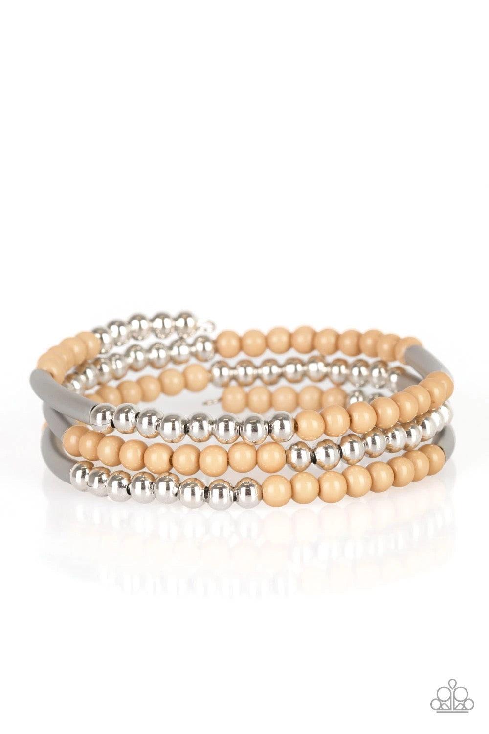 Paparazzi Accessories Tourist Trap - Brown A collection of neutral brown and shiny silver accents are threaded along a long wire to create an infinity wrap bracelet. Coil design allows for an adjustable fit. Sold as one individual bracelet. Jewelry