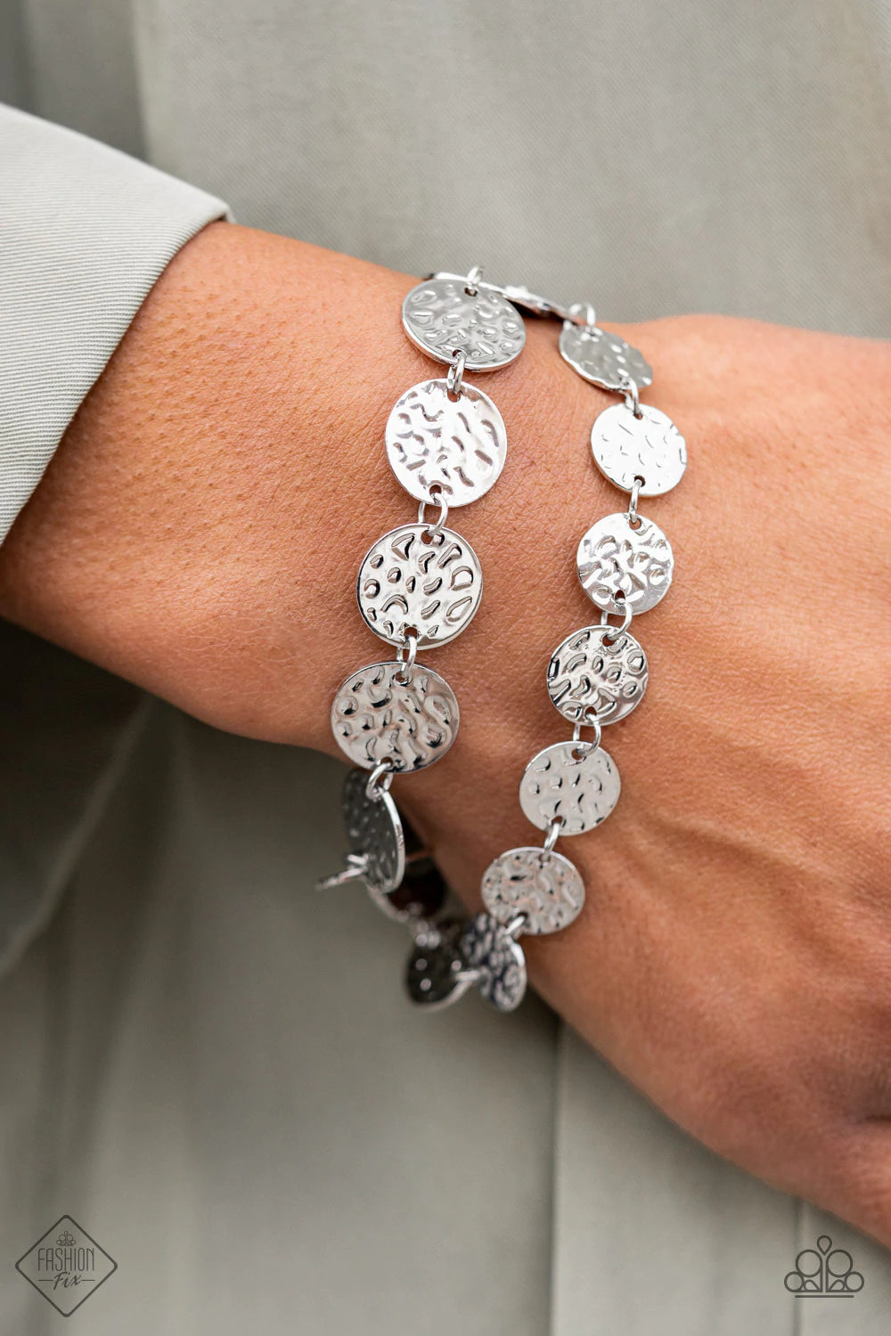 Paparazzi Accessories Rooted To The SPOTLIGHT - Silver Two rows of hammered silver discs wrap around the wrist, creating an edgy shimmer. Features an adjustable clasp closure. Sold as one individual bracelet. Jewelry