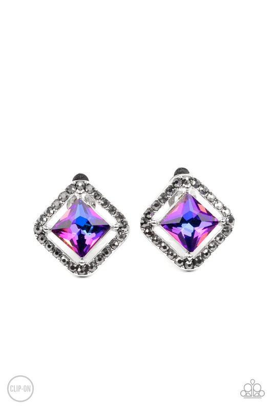 Paparazzi Accessories Cosmic Catwalk - Purple *Clip-On Featuring an iridescent UV finish, an emerald cut purple gem seemingly floats in the center of a hematite rhinestone encrusted frame for a stellar statement. Earring attaches to a standard clip-on fit