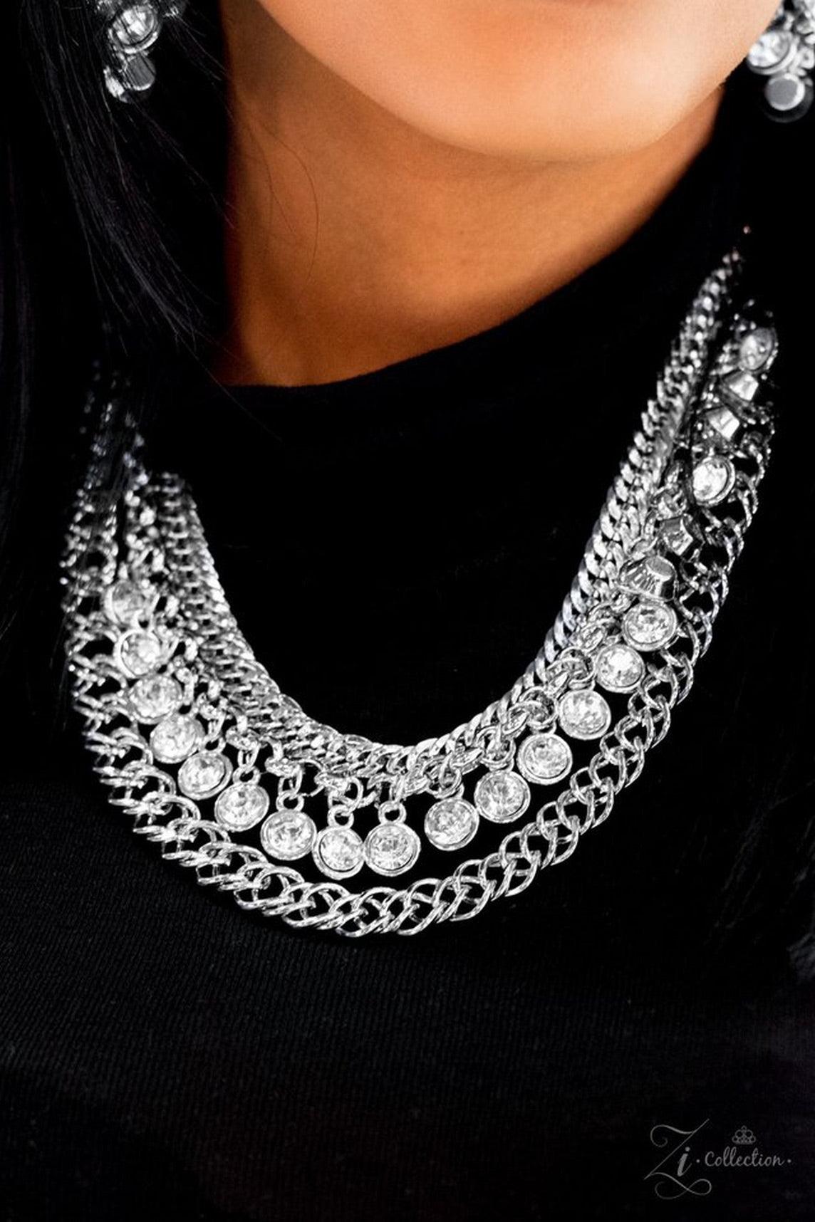 Paparazzi Accessories Powerhouse A row of white rhinestones drip between two rows of bulky silver chains, creating hypnotizing layers. Brushed in a blinding shimmer, the dramatic rows of chain and gems create the ultimate sparkle below the collar. Feature