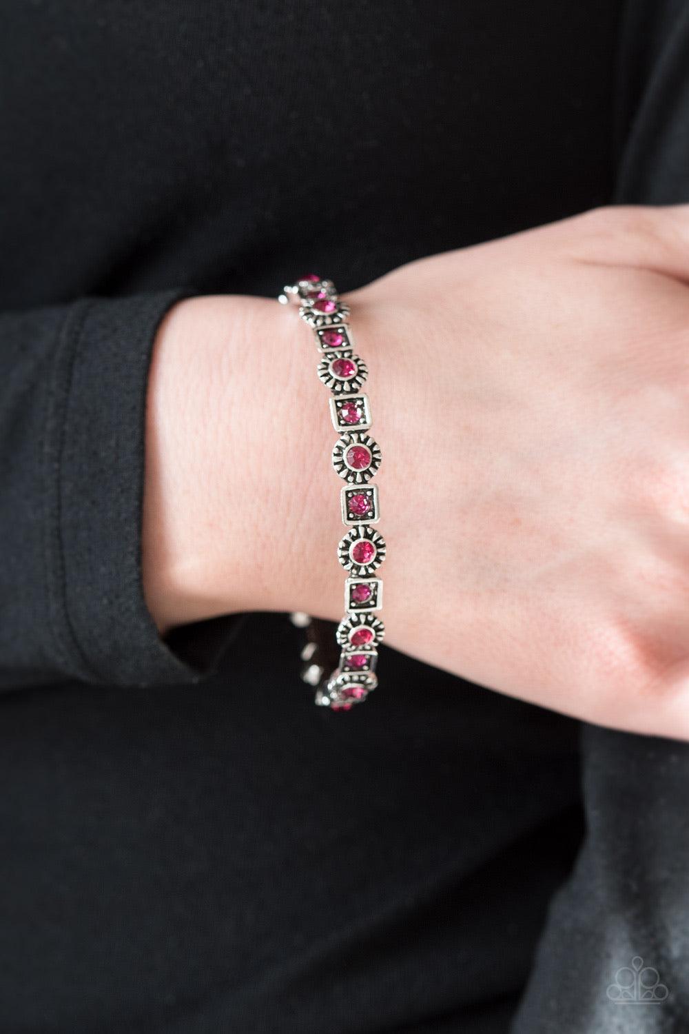 Paparazzi Accessories Spring Inspiration - Pink Sparkling pink rhinestones are pressed into the centers of silver floral and square frames. The glittery frames connect around the wrist, coalescing into a whimsical bangle. Sold as one individual bracelet.