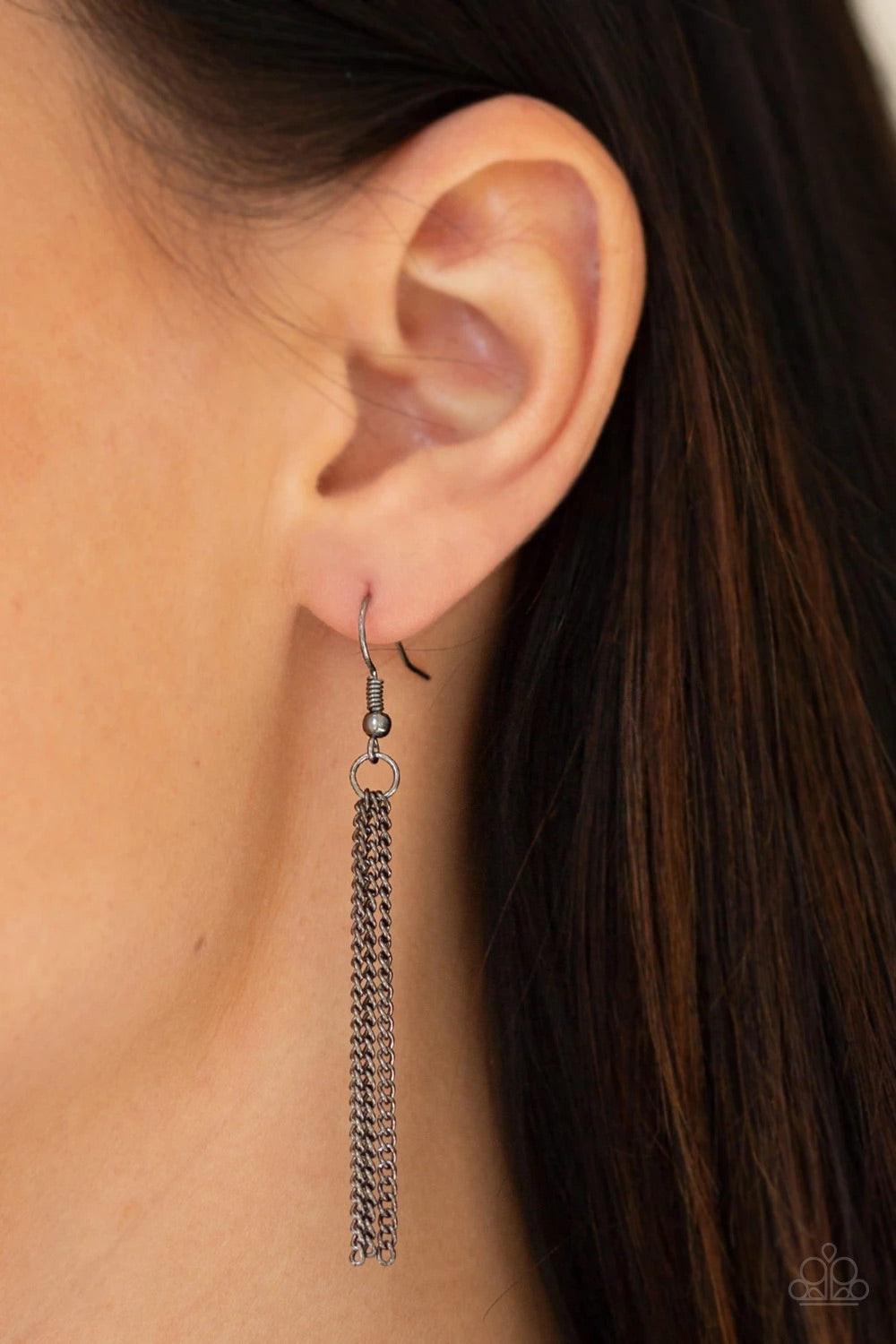 Paparazzi Accessories Timelessly Tasseled - Black Delicately hammered in sections of shimmer, gunmetal circular frames stack into a bold pendant at the bottom of a lengthened gunmetal chain. A shimmery gunmetal tassel swings from the bottom of the stacked