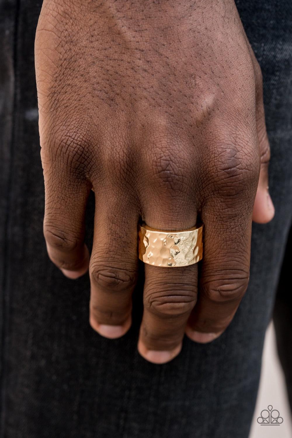 Paparazzi Accessories Self-Made Man - Gold A thick gold band has been hammered in shimmery detail for a metro inspired look. Features a stretchy band for a flexible fit. Jewelry