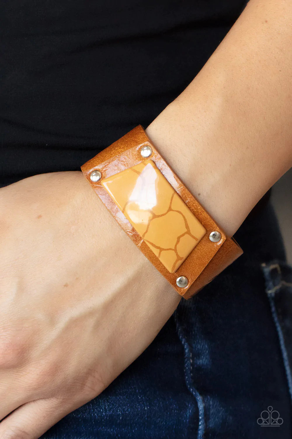 Paparazzi Accessories Geo Glamper - Brown Featuring a faux marble finish, a brown acrylic centerpiece attaches to a tan leather frame that is studded in place along a distressed tan leather band for a colorfully rustic fashion. Features an adjustable snap