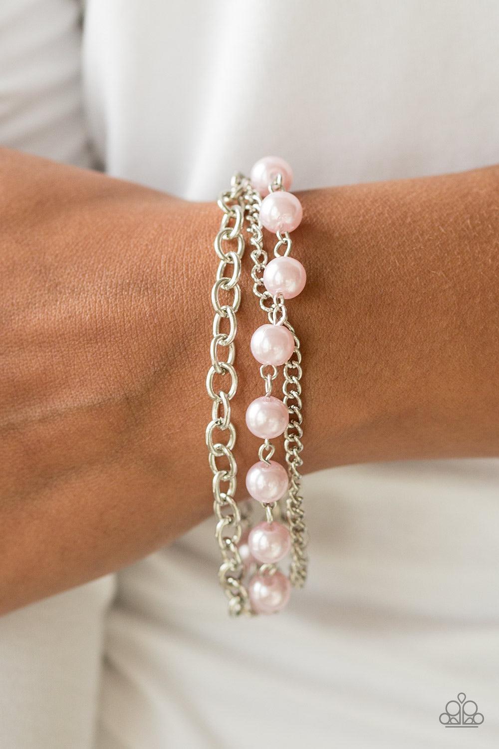Paparazzi Accessories Classically Cambridge - Pink A classic strand of pink pearls joins two mismatched silver chains around the wrist for a refined look. Features an adjustable clasp closure. Sold as one individual bracelet. Jewelry