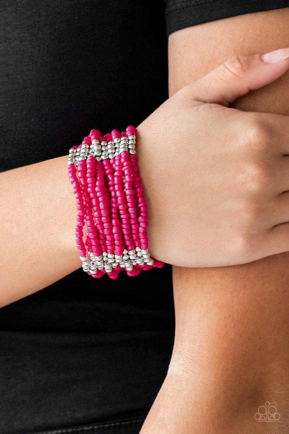 Paparazzi Accessories Outback Odyssey - Pink Joined together with metallic fittings, countless pink seed beads are threaded along stretchy elastic bands. Sections of dainty silver beads are sprinkled along the colorful layers, adding hints of shimmer to t
