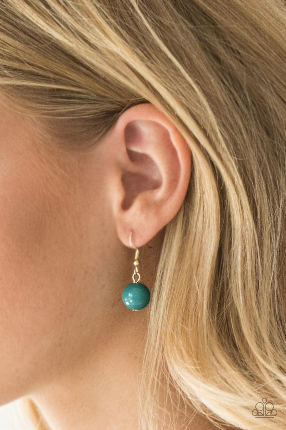 Paparazzi Accessories Tour de Trendsetter - Green Varying in shape, glassy and polished Quetzal Green beads swing from the bottom of interlocking gold chains. Crystal-like teardrops are sprinkled along the colorful beading, creating a flirtatious fringe b