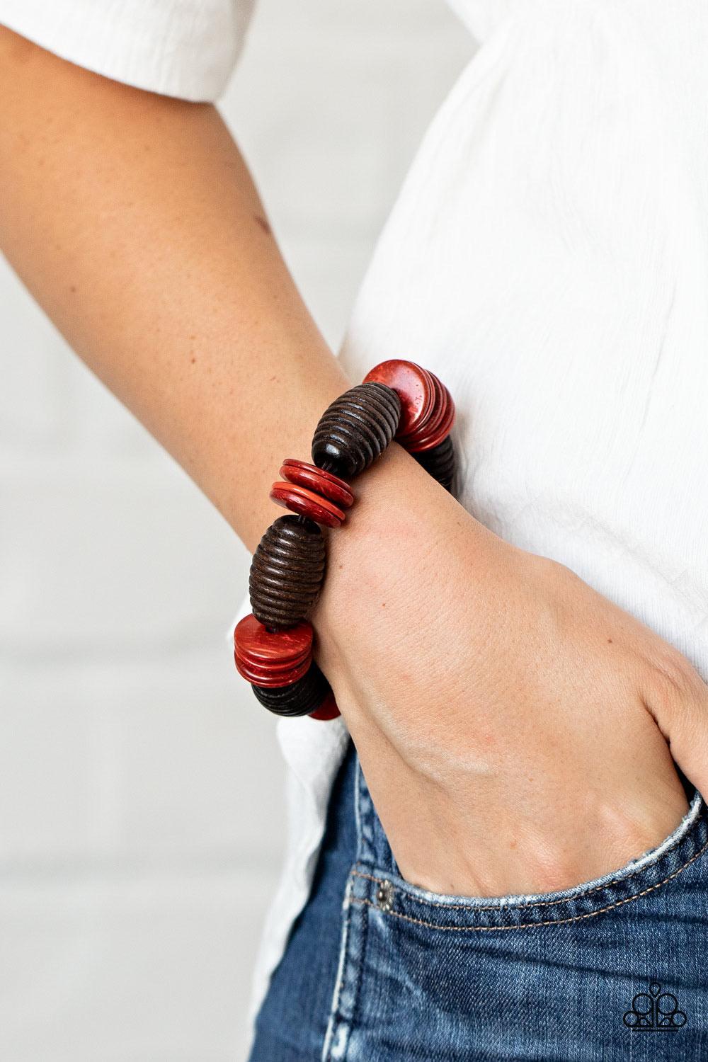 Paparazzi Accessories Caribbean Castaway - Red .A summery collection of oversized brown wooden beads and distressed red wooden discs are delicately threaded along stretchy bands around the wrist for a beach inspired fashion. Sold as one individual bracele