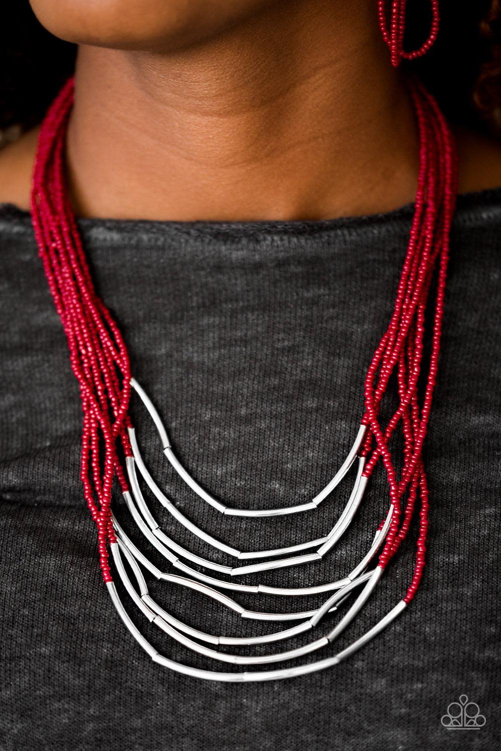 Paparazzi Accessories Living the GLEAM - Red Infused with two large silver fittings, shiny red seed beads are threaded along countless strands, creating dramatic layers below the collar. Shimmery silver accents slide along the centers of the strands, addi