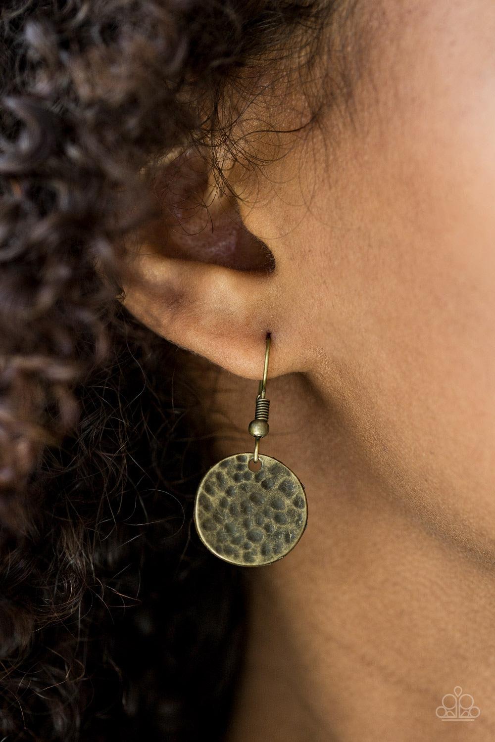 Paparazzi Accessories Treasure HUNTRESS - Brass Delicately hammered in antiqued textures, small and large brass discs alternate below the collar. Three brass discs are brushed in a patina finish for a colorful rustic finish. Features an adjustable clasp c