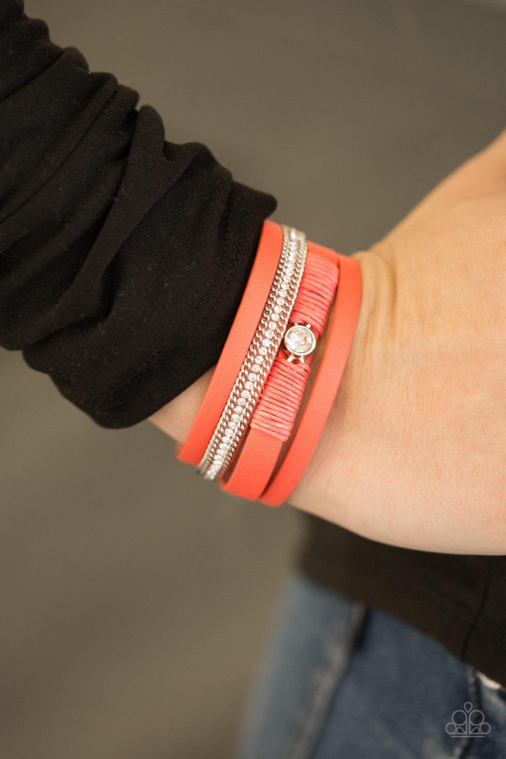Paparazzi Accessories Catwalk Craze - Orange Coral leather strands layer across the wrist. Infused with silver chain and white rhinestone accents, coral cording knots around a leather strand, securing a solitaire white rhinestone in place for a whimsical