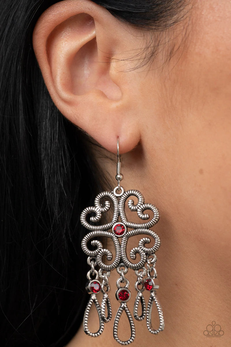 Paparazzi Accessories Majestic Makeover - Red Etched in linear texture, four whimsical hearts coalesce into an airy frame. A dainty red rhinestone dots the center while a flirty fringe of teardrop frames adorned with fiery red rhinestones sways below for