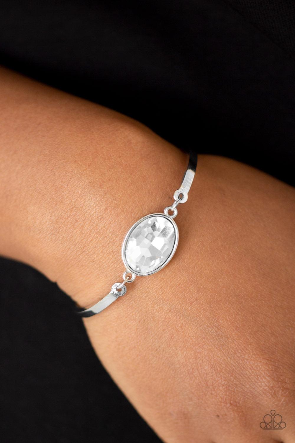 Paparazzi Accessories Definitely Dashing - White Arcing silver bars connect to a faceted white gem centerpiece, creating a dainty cuff-like bracelet around the wrist. Features an adjustable clasp closure. Sold as one individual bracelet. Jewelry