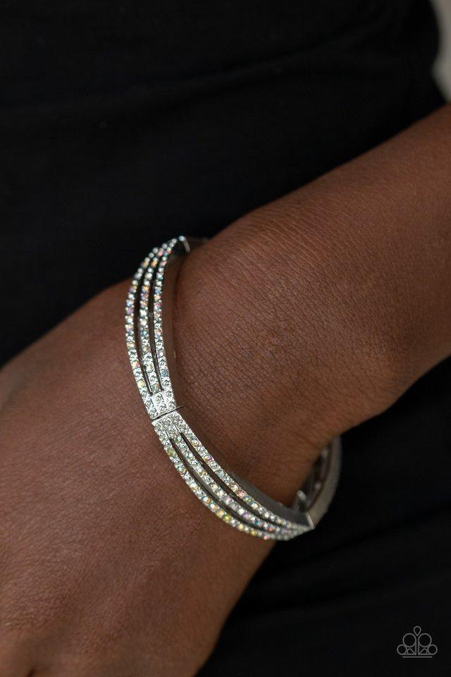 Paparazzi Accessories Suburb Scene - Multi Sporadically dotted in rows of iridescent rhinestones and shiny silver studs, stacked silver frames are threaded along a stretchy band around the wrist for a refined look. Jewelry