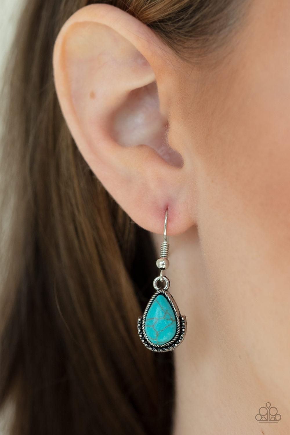 Paparazzi Accessories Stone Monument - Blue Featuring studded silver frames, an asymmetrical collection of refreshing turquoise stones coalesce into an earthy squash blossom pendant at the bottom of a lengthened silver chain. Features an adjustable clasp