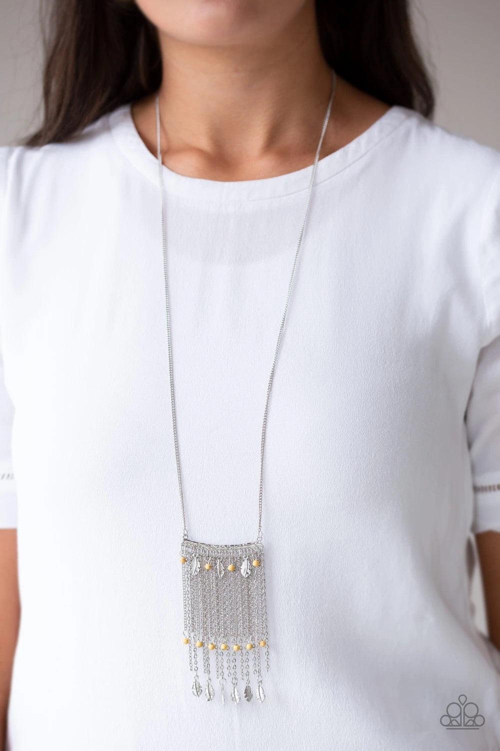 Paparazzi Accessories On The Fly - Yellow Attached to a lengthened silver chain, a hammered silver bar gives way to a fringe of shimmery silver chain, yellow stone beads, and silver feather frames for a seasonal look. Features an adjustable clasp closure.