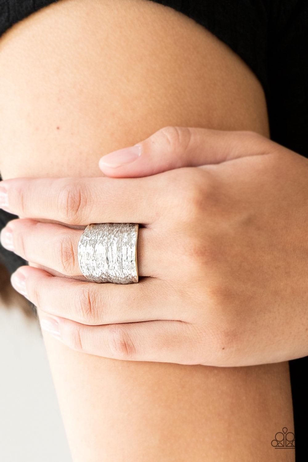Paparazzi Accessories Paleo Patternu - Silver Radiating with patterns derived from nature, a rippling silver frame curves around the finger for a bold look. Features a stretchy band for a flexible fit. Jewelry