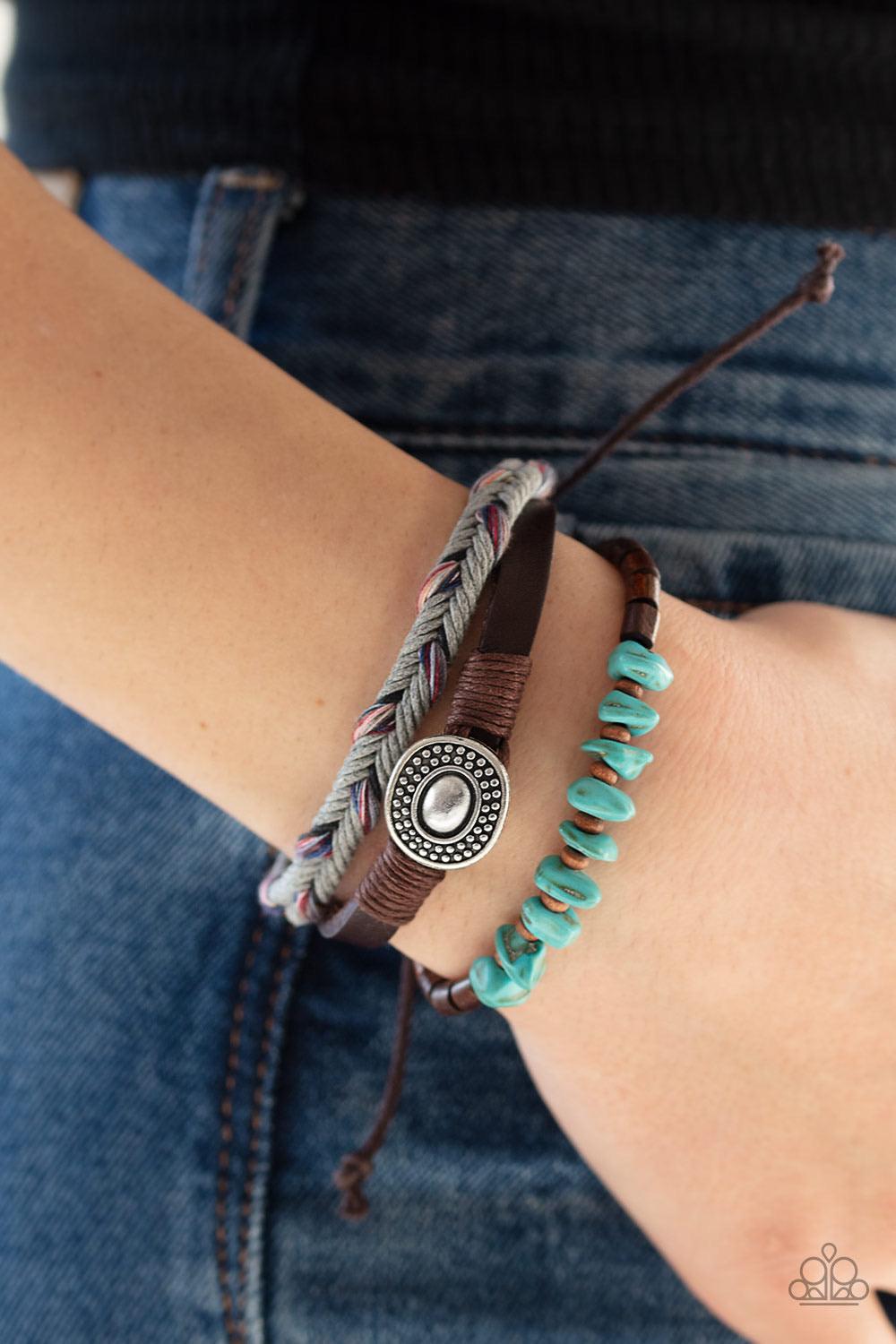 Paparazzi Accessories Find Your Path - Multi Colorfully braided cording, a thick leather band, and a strand of wooden beads and refreshing turquoise stones layer across the wrist for a seasonal look. Features an adjustable sliding knot closure. Sold as on