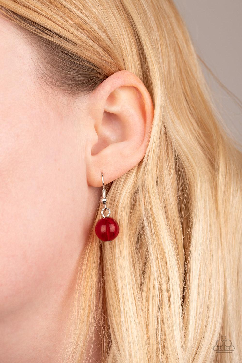 Paparazzi Accessories Sorry To Burst Your Bubble - Red Attached to a bold silver chain, round opaque red beads are threaded along an invisible wire below the collar. Attached to a net of silver chains, faceted opaque teardrops cascade from the bottom of t