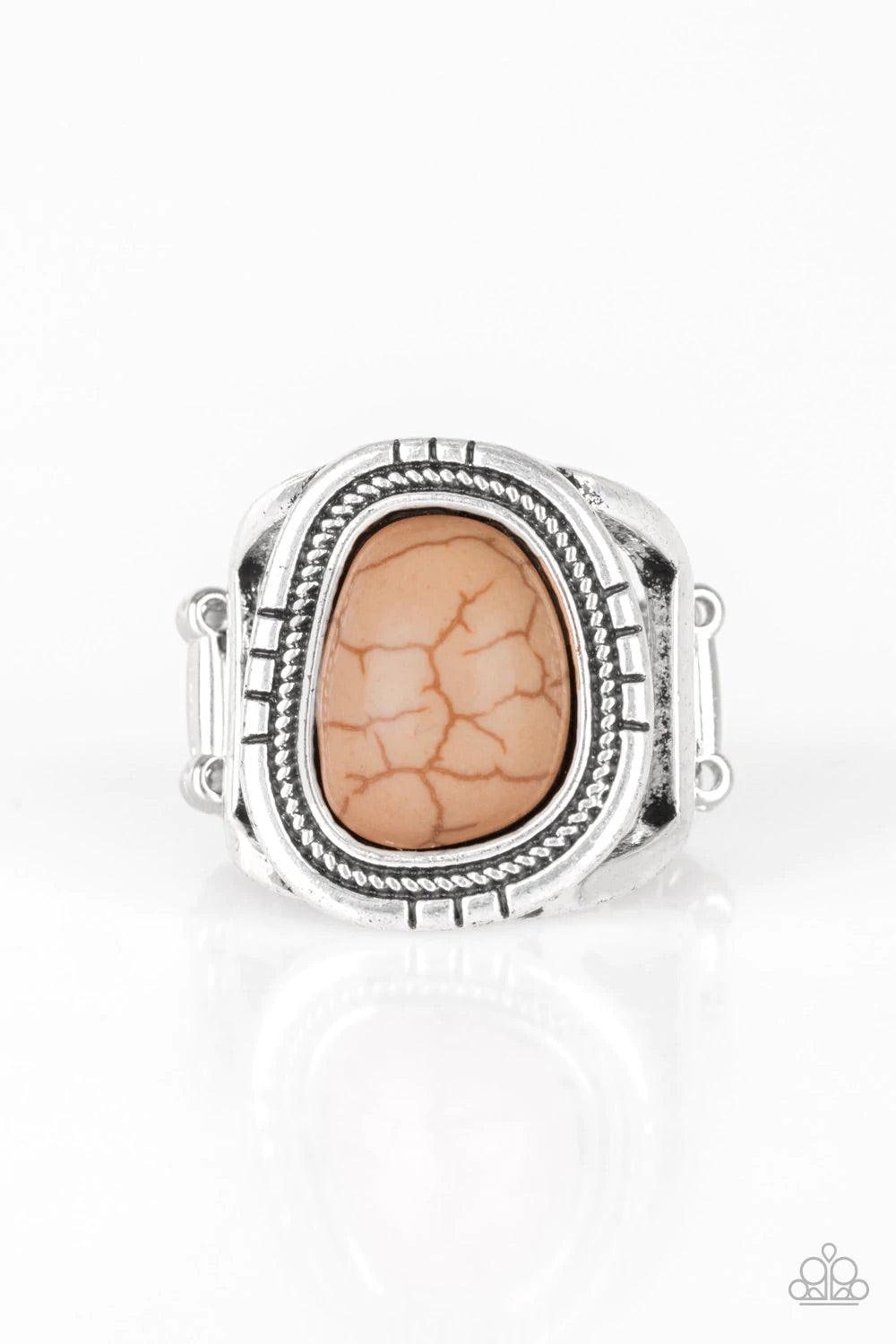 Paparazzi Accessories Out On The Range - Brown An earthy brown stone is pressed into an asymmetrical silver frame radiating with tactile textures for a seasonal look. Features a stretchy band for a flexible fit. Sold as one individual ring. Jewelry