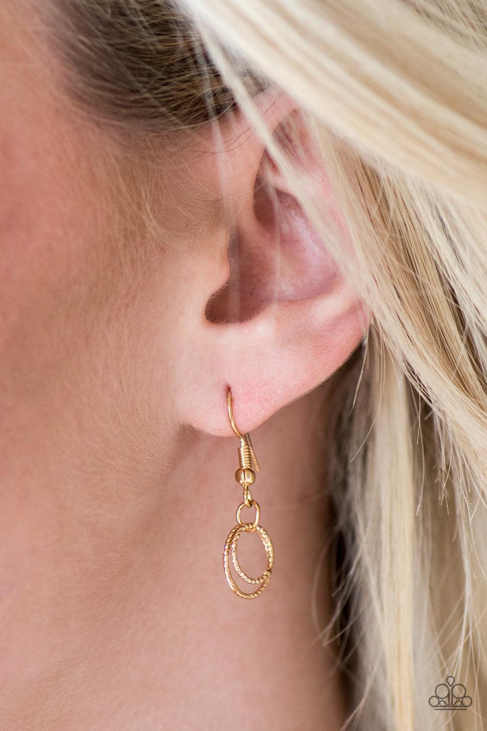 Paparazzi Accessories One Ring LEADS To Another - Gold Delicately etched in radiant textures, dainty gold rings join below the collar in a dizzying fashion. Features an adjustable clasp closure. Jewelry