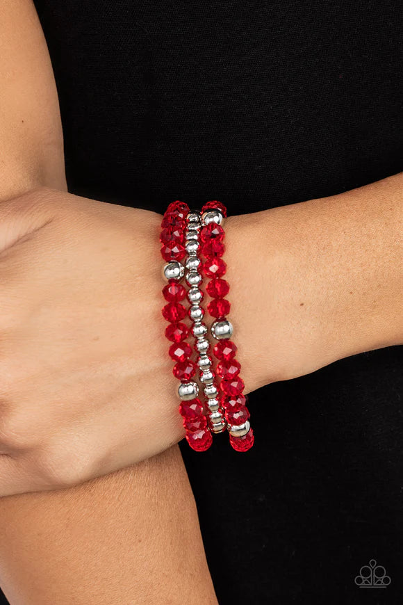 Paparazzi Accessories Prismatic Perceptions - Red A playful collection of shiny silver beads and sparkly red crystal-like beads are threaded along stretchy bands around the wrist, resulting in colorful layers. Sold as one set of three bracelets. Jewelry
