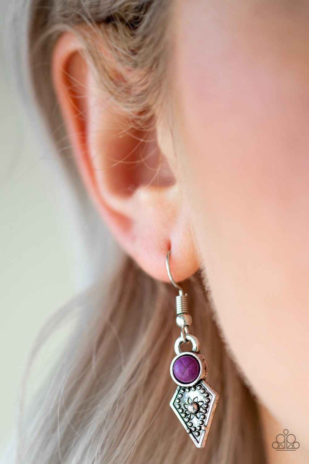 Paparazzi Accessories Jurassic Jamboree - Purple Featuring glassy and polished finishes, round and asymmetrical purple beads trickle from the bottom of a double-linked silver chain. An additional silver chain is layered above the summery beading for a sea