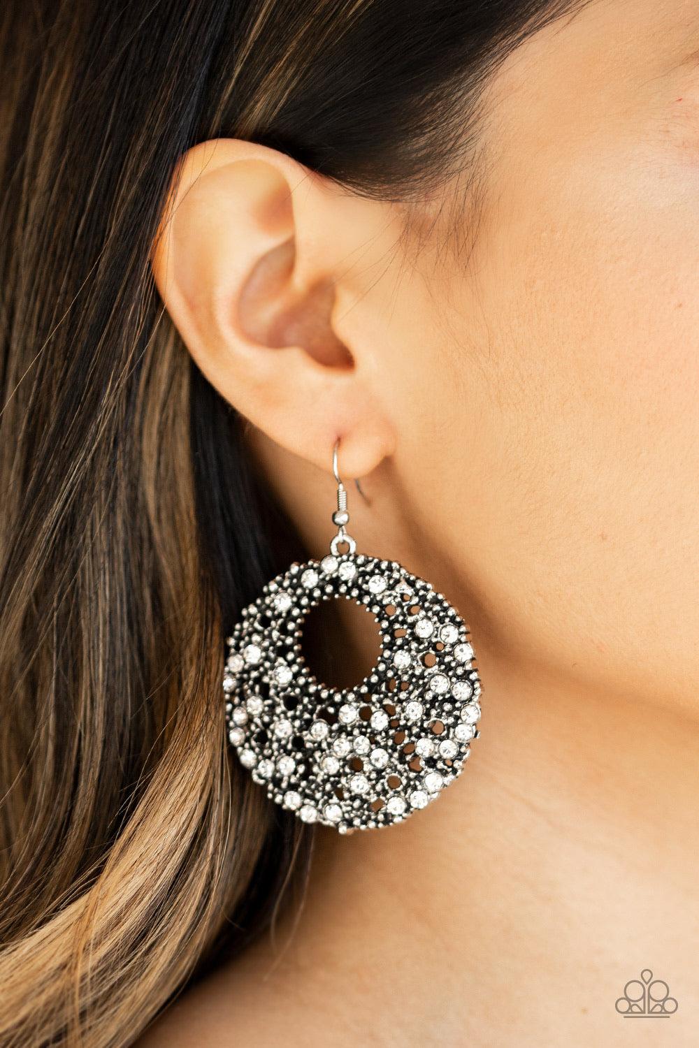 Paparazzi Accessories Starry Showcase - Black A collision of antiqued silver studs and glassy white rhinestones coalesce into a stellar hoop for an edgy look. Earring attaches to a standard fishhook fitting. Jewelry