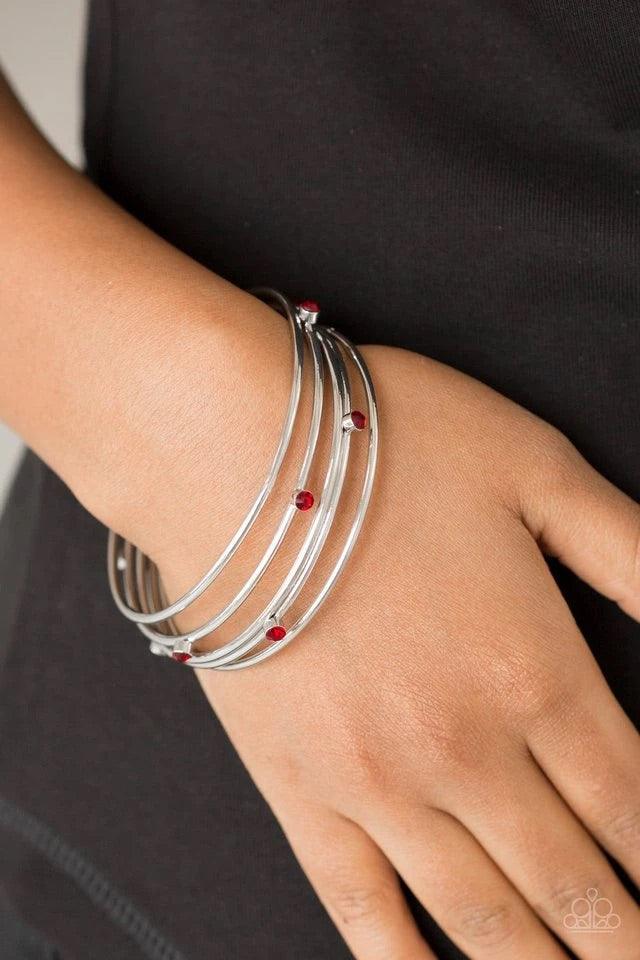 Paparazzi Accessories Delicate Decadence - Red Three shiny silver and two red rhinestone encrusted bangles stack across the wrist for a refined look. Sold as one set of five bracelets. Jewelry