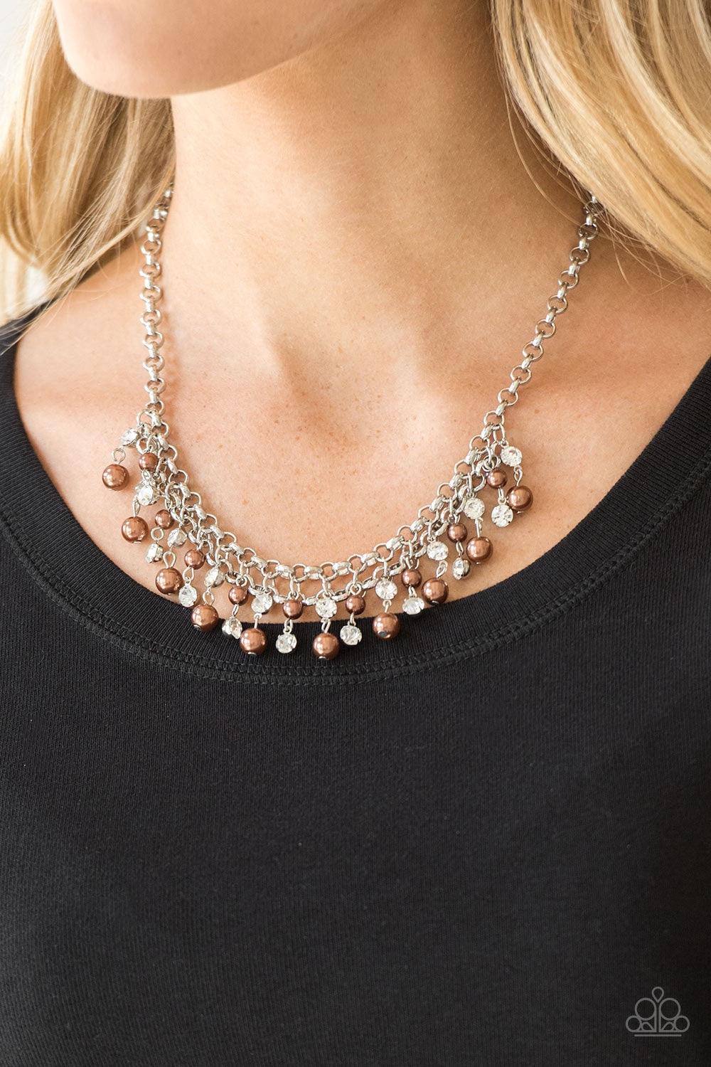 Paparazzi Accessories You May Kiss The Bride - Brown Glittery white rhinestones and classic brown pearls swing from the bottom of interlocking silver chains, creating a bubbly fringe below the collar. Features an adjustable clasp closure. Jewelry