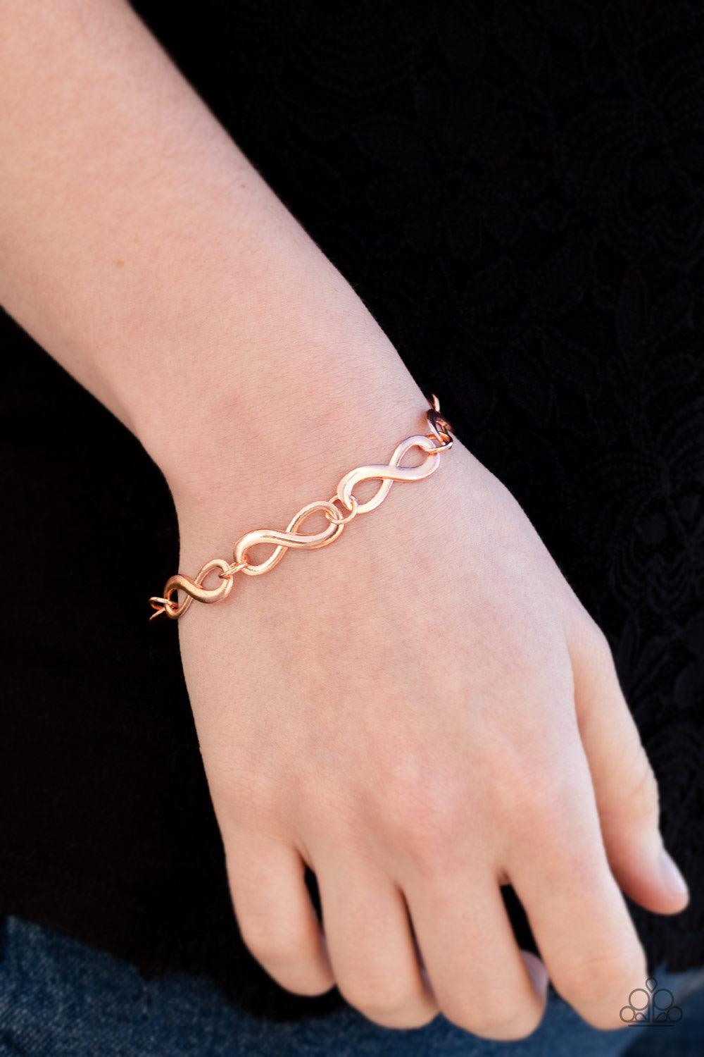 Paparazzi Accessories Give Me Time - Copper Glistening copper infinity charms link around the wrist. Brushed in an incandescent shimmer, the elegant infinites join into a timeless palette. Features an adjustable clasp closure. Jewelry