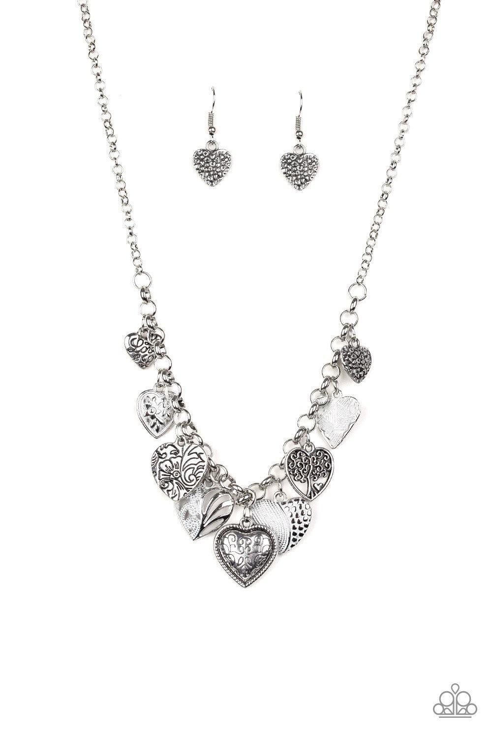 Paparazzi Accessories Grow Love - White Featuring an array of floral patterns, a collection of silver hearts swing from the bottom of a shimmery silver chain. Alternating charms are brushed in a shiny white finish, creating a colorful fringe below the col